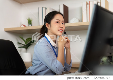 Focused Customer Service Representative. Female agent contemplating while assisting clients on a call. Focused Customer Service Representative. Female agent contemplating while assisting clients on a call. 127906978