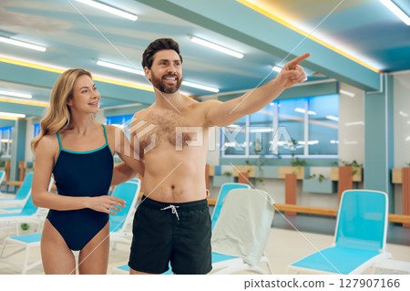 Young cute couple in swimwear in the swimming pool 127907166