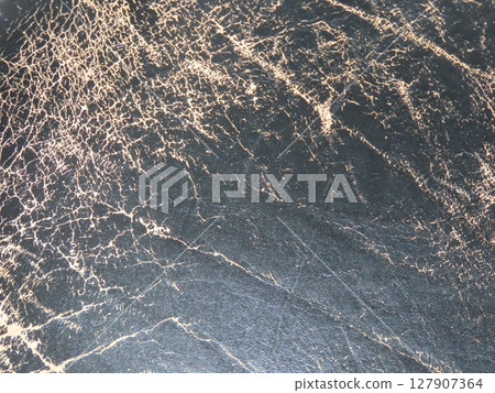 Close-up texture of deteriorated black genuine leather (chair seat) Close-up texture of deteriorated black genuine leather (chair seat) 127907364