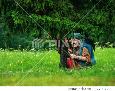 Baba Yaga with a raven on her shoulder 127907720