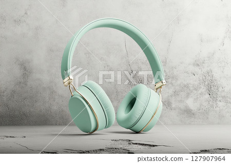 A mint green color headphones on cracked concrete background. 127907964