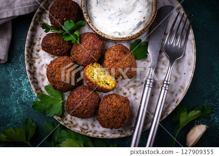 Middle Eastern falafel balls with sauce 127909355