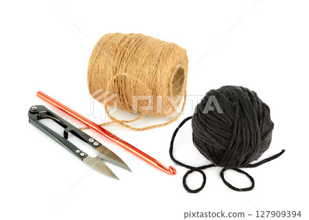 Balls of yarn, scissors and crochet hook isolated on white background. Balls of yarn, scissors and crochet hook isolated on white background. 127909394