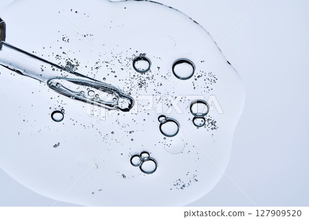 The bubbly texture of a face serum with a pipette. View from below. 127909520