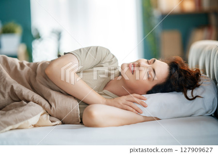 Woman is sleeping in her bedroom Woman is sleeping in her bedroom 127909627