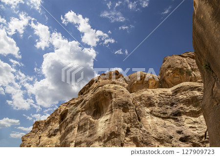 Mountains of Petra (against the background of a beautiful sky with clouds), Jordan, Middle East. Petra has been a UNESCO World Heritage Site since 1985 Mountains of Petra (against the background of a beautiful sky with clouds), Jordan, Middle East. Petra has been a UNESCO World Heritage Site since 1985 127909723