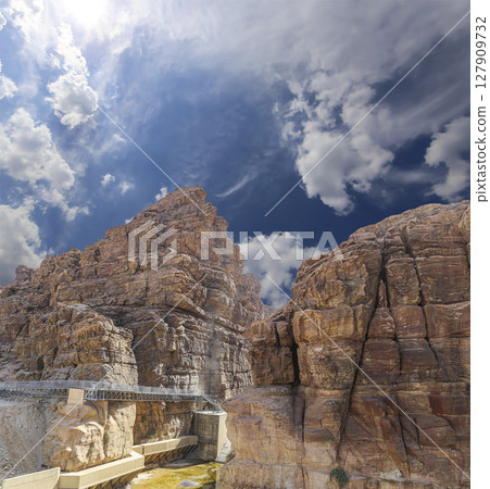 Mountains of Petra (against the background of a beautiful sky with clouds), Jordan, Middle East. Petra has been a UNESCO World Heritage Site since 1985 Mountains of Petra (against the background of a beautiful sky with clouds), Jordan, Middle East. Petra has been a UNESCO World Heritage Site since 1985 127909732