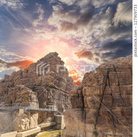 Mountains of Petra (against the background of a beautiful sky with clouds), Jordan, Middle East. Petra has been a UNESCO World Heritage Site since 1985 Mountains of Petra (against the background of a beautiful sky with clouds), Jordan, Middle East. Petra has been a UNESCO World Heritage Site since 1985 127909733