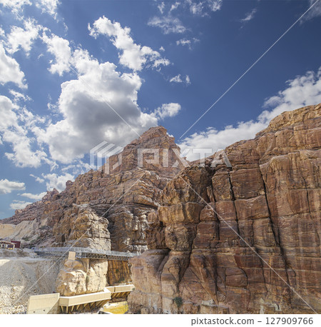 Mountains of Petra (against the background of a beautiful sky with clouds), Jordan, Middle East. Petra has been a UNESCO World Heritage Site since 1985 Mountains of Petra (against the background of a beautiful sky with clouds), Jordan, Middle East. Petra has been a UNESCO World Heritage Site since 1985 127909766