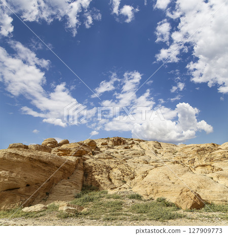 Mountains of Petra (against the background of a beautiful sky with clouds), Jordan, Middle East. Petra has been a UNESCO World Heritage Site since 1985 Mountains of Petra (against the background of a beautiful sky with clouds), Jordan, Middle East. Petra has been a UNESCO World Heritage Site since 1985 127909773