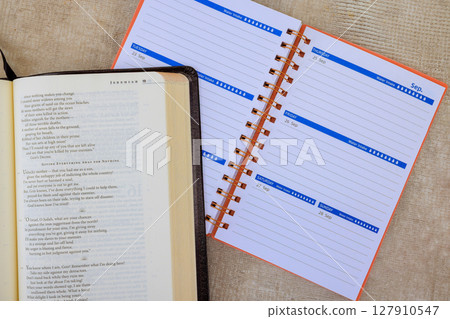 24 April 2025 Washington DC US An open Bible Holy book beside planner highlights value of reading organization for time management. 127910547