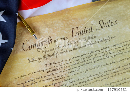 10 June 2025 Washington DC This historical parchment document shows resolutions from early U.S. alongside American flag fabric 10 June 2025 Washington DC This historical parchment document shows resolutions from early U.S. alongside American flag fabric 127910581