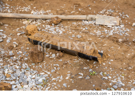 Fresh soil core sample placed on the ground after drilling. Subsurface material collected for geotechnical testing and laboratory analysis 127910610