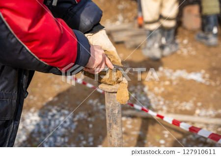 Man cutting and cleaning soil sample for laboratory analysis. Preparation of core material for geotechnical testing and scientific evaluatio Man cutting and cleaning soil sample for laboratory analysis. Preparation of core material for geotechnical testing and scientific evaluatio 127910611