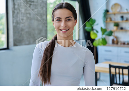 Happy young teenage girl looking at camera at home Happy young teenage girl looking at camera at home 127910722