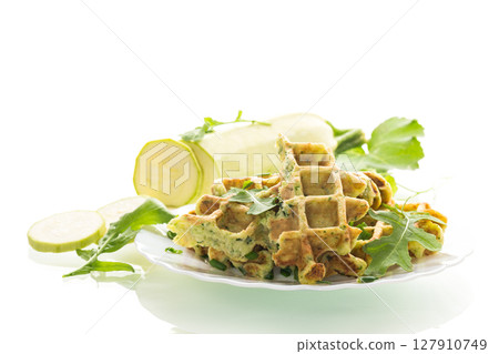 Crispy vegetable waffles served with herbs on white background Crispy vegetable waffles served with herbs on white background 127910749