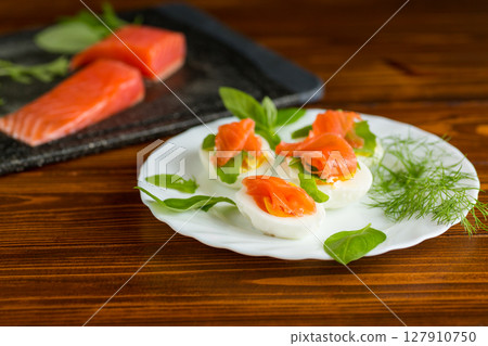Appetizer of boiled eggs and lightly salted salmon with dill Appetizer of boiled eggs and lightly salted salmon with dill 127910750