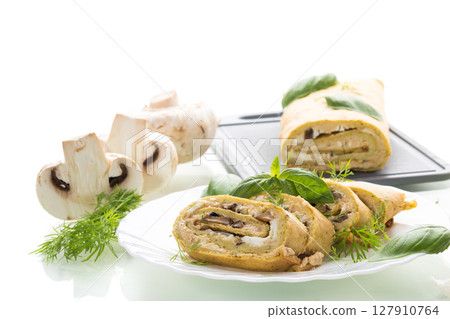 Homemade zucchini roll with mushroom filling on a white background 127910764