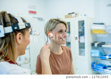 Female patient undergoing ear check-up at specialist appointment 127911045