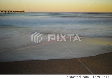 Waves crashing on the sandy beach in the early morning Waves crashing on the sandy beach in the early morning 127911514