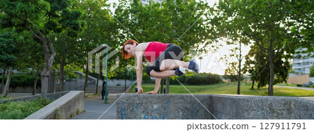 Woman working out in the city, doing bodyweight strength exercises outdoors 127911791
