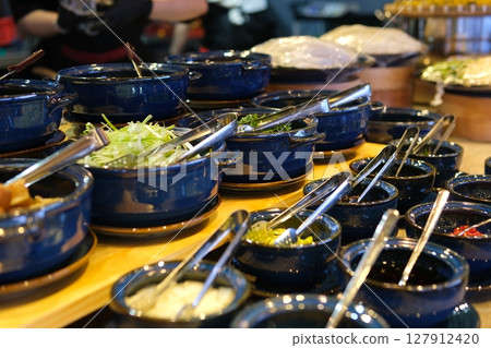 Lumber plate with assorted aromatic spiced falling on table and spilling mix on table Lumber plate with assorted aromatic spiced falling on table and spilling mix on table 127912420