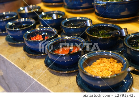Lumber plate with assorted aromatic spiced falling on table and spilling mix on table Lumber plate with assorted aromatic spiced falling on table and spilling mix on table 127912423