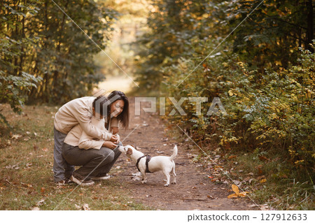 Mother and Son Laughing While Walking Dog in Forest 127912633