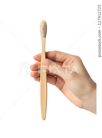 Hand holding bamboo toothbrush, eco-friendly dental care on transparent background Hand holding bamboo toothbrush, eco-friendly dental care on transparent background 127912725
