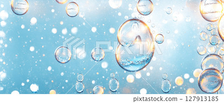 sparkling ethereal background featuring numerous transparent bubbles and floating particles against a soft blue gradient 127913185