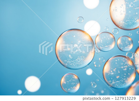 vibrant and luminous background featuring various transparent bubbles of different sizes floating in clear blue liquid with sparkling highlights 127913229