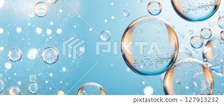 vibrant and luminous background featuring various transparent bubbles of different sizes floating in clear blue liquid with sparkling highlights vibrant and luminous background featuring various transparent bubbles of different sizes floating in clear blue liquid with sparkling highlights 127913232