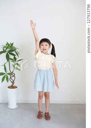 Child raising hand 127913796
