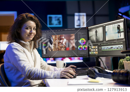 Portrait of jolly video editor using special effects and editing software packages to upgrade footage shot by production teams. Happy videographer finishing project in multimedia agency Portrait of jolly video editor using special effects and editing software packages to upgrade footage shot by production teams. Happy videographer finishing project in multimedia agency 127913913