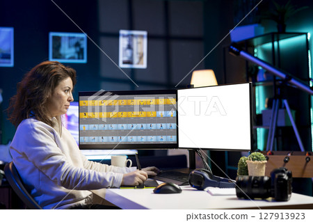 Photographer uses photo editing software on isolated screen PC display in studio. Freelancer uses photographs retouching program on mockup computer monitor, making adjustment with graphic tablet 127913923