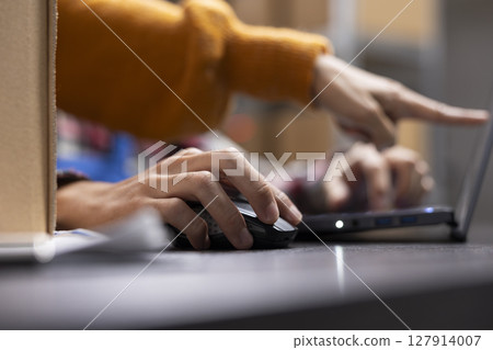 Small business staff members prepare goods and boxes for local shipment, retail depot. Asian people work on efficient order processing and express shipment for a growing local brand. 127914007
