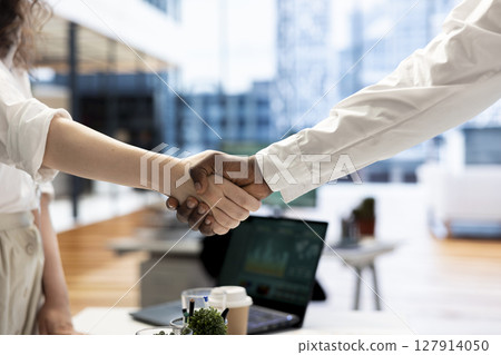 Businessmen in office shaking hands after finishing lucrative financial agreement for company. Close up of manager meeting with man, doing welcoming handshake gesture before starting conversation 127914050