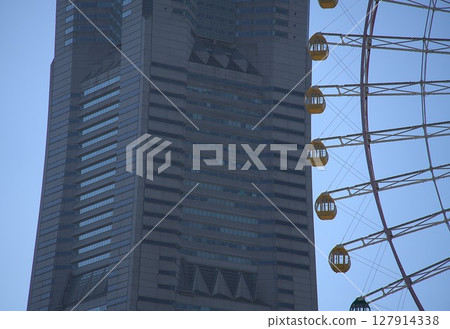 Tall building and Ferris wheel Tall building and Ferris wheel 127914338