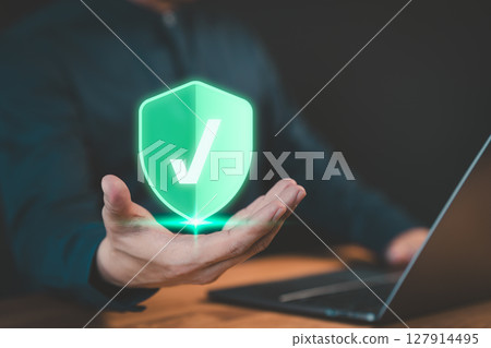 Man is showing on hand identity proofing icon for security protection system on virtual screen. Concept of Quality assurance of business service, Certified guarantee approval or secure access system. 127914495