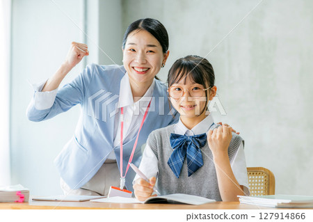 Female junior high school student and teacher studying 127914866