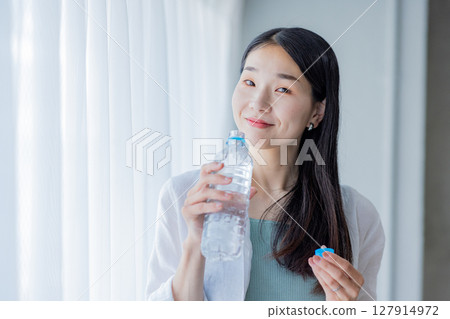 Young woman drinking water Young woman drinking water 127914972