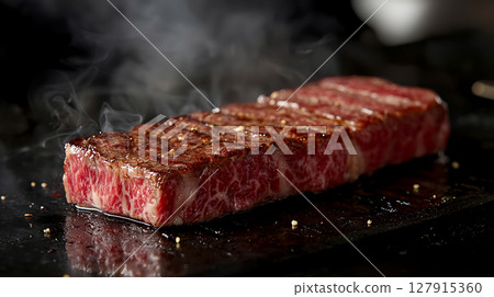 Delicious beef steak meat grilled on a hot plate 127915360