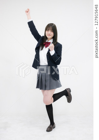 Full body of a high school girl doing a fist pump on a white background Full body of a high school girl doing a fist pump on a white background 127915648