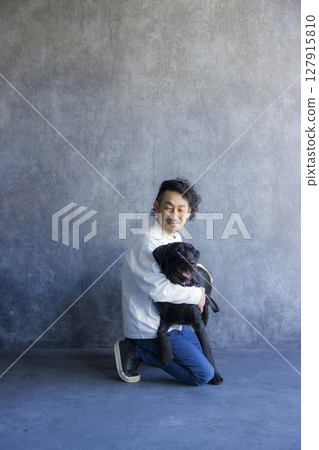 Man relaxing with his dog 127915810