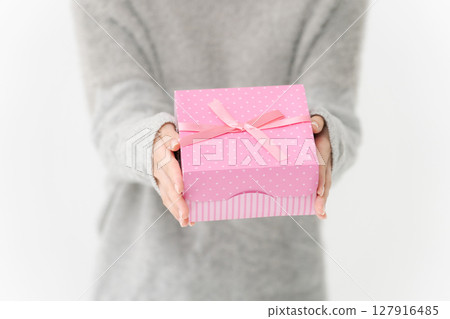 A young lady with a present 127916485