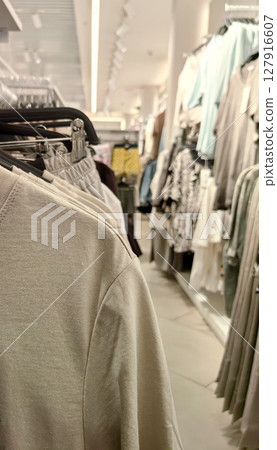 stylish lightweight blouses displayed on hangers in boutique for summer fashion. closeup. 127916607