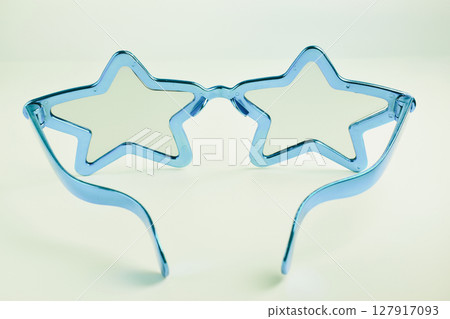 blue star shape of glasses on old sepia background 127917093