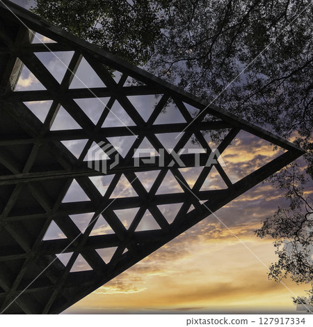Triangular Lattice Structure Against a Colorful Sky, Auroville, Tamil Nqdu. Triangular Lattice Structure Against a Colorful Sky, Auroville, Tamil Nqdu. 127917334