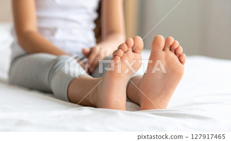 Child showing the soles of his bare feet 127917465