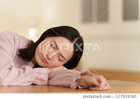 A woman falling asleep at night 127919163